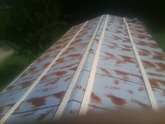 Rusted metal roof panels with new wood purlins before replacement — Storm Damage Roof Repair in Rancho Mirage by Roofing Brothers